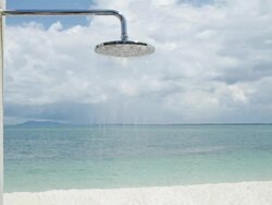MS Outdoor shower on beach / Nikkoi Island, Bintan, Indonesia Stock Footage