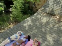 Women tanning on roof Stock Footage