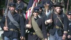 Union soldiers march with Unions flags as cavalrymen follow during the Civil War. Stock Footage