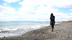lonely woman walking on the beach Stock Footage