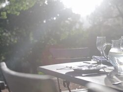 Sunbeam on table with luxury place settings in backyard Stock Footage