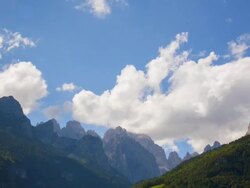 WS T/L ZI Shot of Paragliders circling at alpine mountain peaks "Dolomiti di Brenta" / Molveno, Trentino, Italy Stock Footage