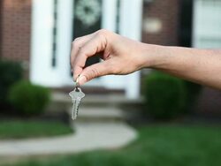 Man's Hand Holding Keys In Front Of House Stock Footage