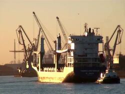 WS View of shipyard and ship floating in river with small boat / Hamburg, Hamburg, Germany Stock Footage