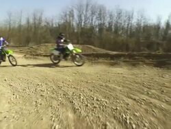 HD CRANE: MX Riders Speeding Along Track Stock Footage