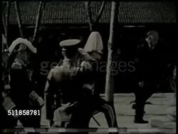 1932: MANCHUKUO: Japanese installed Head of State Puyi walking in front of others in full uniform & into building, people bowing in courtyard, VS People & unidentified officers outside. (Japanese 'Puppet State') Instructional Video
