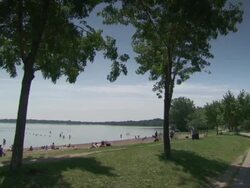WS PAN People resting near lake / Minneapolis, Minnesota, United States  Stock Footage
