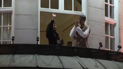 Torchlight parade in celebration of peace prize laureates; joint winners wave from balcony News Clip