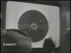 1944: XXI BOMBER COMMAND HEADQUARTERS: WS Jeep driving toward Headquarters (HQ) of 21st Bomber Command. INT VS Pilots watching radar scope, male at board talking about bombing targets (SOT). World War II, WWII, strategy, attack plan, Pacific Front Instructional Video