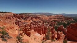 Pull back to reveal a hiker mother pointing out over Bryce Canyon to her son Stock Footage
