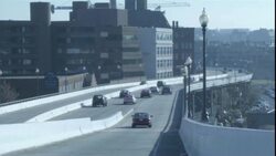 Cars travel over a highway ramp in Washington, DC. Stock Footage