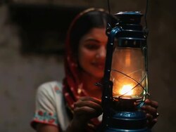 Woman burning lantern at night, Faridabad, Haryana, India  Stock Footage