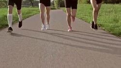 SLO MO TS Legs of runners running on a road Stock Footage