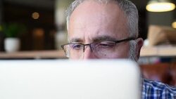 Adult senior bearded man sitting with a laptop Stock Footage