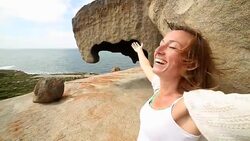 Young woman arms outstretched towards the sea Stock Footage