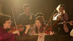 Smiling people playing instruments in orchestra Stock Footage