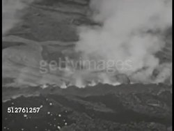 1943: PACIFIC ISLANDS: AERIAL VS Islands w/ volcanic activity, smoke, smoking mountain. Low altitude WS Mount Suribachi at tip of Iwo Jima, passing Iwo Jima. Instructional Video