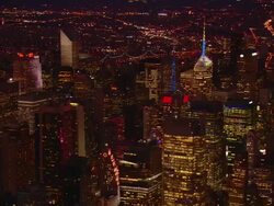 Aerial -Evening shot of illuminated buildings of mid-town Manhattan with a slow turning ZI to the intersection of W. 42nd Street and Broadway. Stock Footage