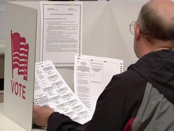 MS, Man looking at ballot paper sitting in voting booth, St. Marys, Ohio, USA Stock Footage