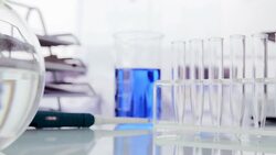 Beakers and test tubes on table Stock Footage