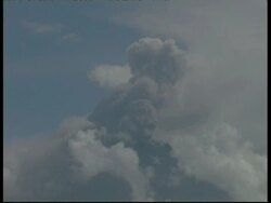 CU large cloud grey smoke and ash cloud billowing from crater into blue sky, Mount Tunguragua, Ecuador Stock Footage