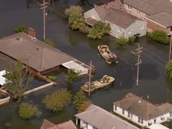 Aerial zoom in marines on amphibious military vehicles in flooded Gentilly subdivision / /New Orleans, low angle Stock Footage