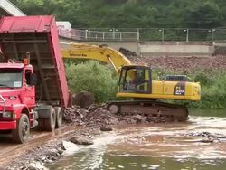 MS Shot of excavator crane working at construction site for new bridge, Saar river / Wiltingen, Rhineland-Palatinate, Germany Stock Footage