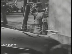 1930s: JAPAN: RISE OF MILITARISM: Black sedans entering gated, guarded compound. General Hideki Tojo (1884-1948) & Foreign Minister Yosuke Matsuoka walking from car. Instructional Video