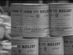 1953: REFUGEES: BERLIN, GERMANY:  VS People handing out cold cans of meat paste to East Berlin refugees in camp, cans w/ label, 'Food for Relief' (Relief Committee), various children waiting. Ration, rations, Berlin Wall Instructional Video