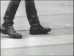 Barbed wire surrounds a stone fortress guarded by soldiers. News Clip