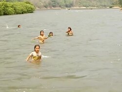 MS ZI SLO MO Shot of children swimming in river / Ou river, Luang Prabang, Laos Stock Footage