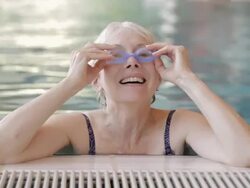 CU Swimmer putting on goggles and swimming in an indoor pool / Vancouver, British Columbia, Canada Stock Footage