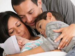MS TU Mother, Father, and Young Son with Newborn Laying in Hospital Bed / Richmond, Virginia, USA Stock Footage