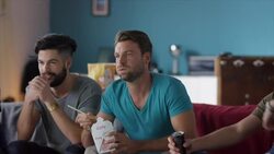 Guys sitting on couch watching tv disappointed Stock Footage