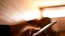 Woman using phone in bed Stock Footage