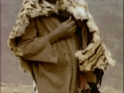 MS tilt up young African child wearing cheetah skin, Ethiopia, Africa Stock Footage