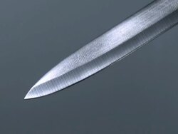 CU Shot of Knife with Blood Dripping from Blade against Grey Background / Calvados, Normandy, France Stock Footage