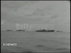 1944: PACIFIC THEATER: Angled XWS Line of ships on ocean in silhouette. WS PAN US Navy Amphibious Forces ships, VS Sailors attaching side support rack, sorting rockets, screwing off nose cap, stacking shells in rack. WWII, World War II. Instructional Video