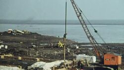 1969 MONTAGE Crane setting vertical risers in place during building of the hoverport at Pegwell Bay / Ramsgate, Kent, England Stock Footage