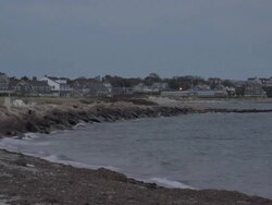 Pan from ocean to houses on Cape Cod Stock Footage