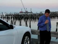 MS Man talking on bluetooth nearby ocean / Portland, ME, United States Stock Footage