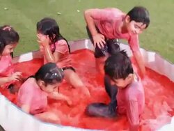 Group of kids playing holi festival in a lawn  Stock Footage