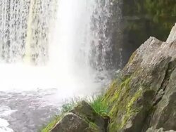 Waterfall Behind Mossy Rocks Stock Footage