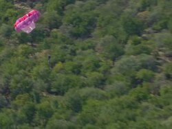 MS TS ZO SLO MO Shot of Paraglider being pulling behind speed boat and Sun City Dam / North West Province, South Africa Stock Footage