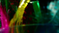Black background with colored glass and feathers slowly rotaing Stock Footage
