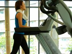 Beautiful woman walking on treadmill Stock Footage