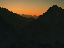 Flying over mountains at sunrise or sunset. Stock Footage