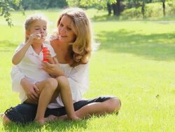 Mother and daughter having fun in park Stock Footage