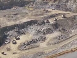 WS AERIAL View of trucks working in opencast mine / South Africa Stock Footage