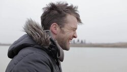 Young man laughing on frozen pond in winter in rural Montana, USA. Stock Footage